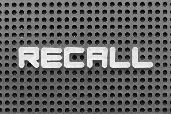 The word 'RECALL' displayed on a perforated surface