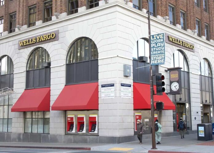 Exterior view of a Wells Fargo bank with red awnings and a street sign