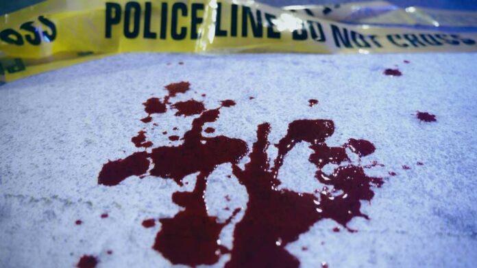 Blood stains on a surface with police caution tape in the background