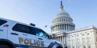 Police vehicle outside United States Capitol building.