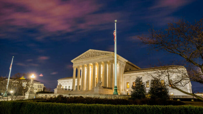 shutterstock_1355731721.jpg The United States Supreme Court building at dusk.