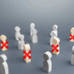 Wooden figures with red X marks, signifying eliminated individuals.