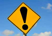 Trump Security Failure — What Are They HIDING? Yellow caution sign with exclamation mark symbol.