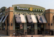 Exterior view of a Panera Bread restaurant with outdoor seating