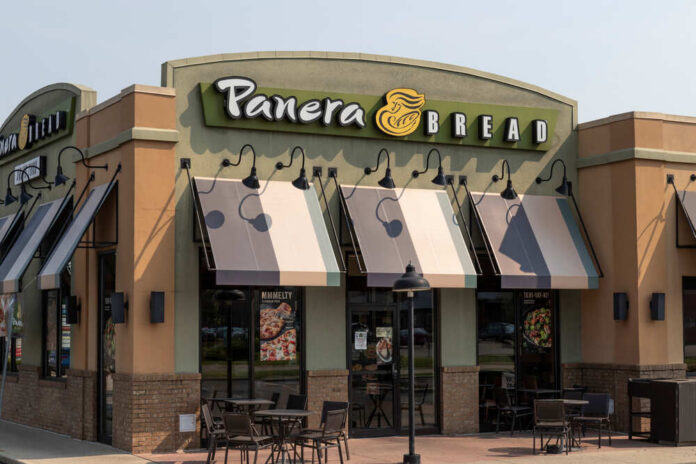 Exterior view of a Panera Bread restaurant with outdoor seating