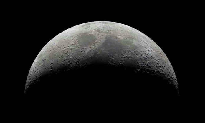 Half moon in a black sky with visible craters.