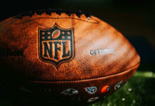 Close-up of an NFL football on grass.