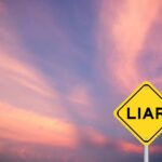 A yellow warning sign with the word 'LIAR' against a colorful sky