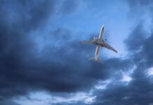 An airplane flying through a cloudy sky