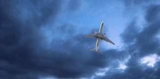 An airplane flying through a cloudy sky