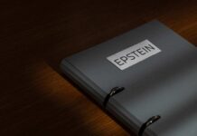 Ambassador ARRESTED — Epstein Cash Bombshell A gray folder labeled 'EPSTEIN' resting on a wooden surface