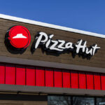 Pizza Hut restaurant sign against a clear blue sky