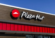 Pizza Hut restaurant sign against a clear blue sky
