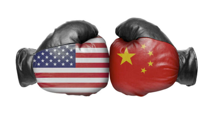 American and Chinese flag boxing gloves facing off