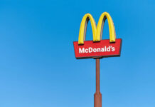 McDonald's restaurant sign against a clear blue sky