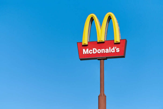 McDonald's restaurant sign against a clear blue sky