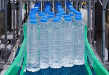 Conveyor belt with rows of bottled water ready for packaging
