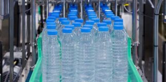 Conveyor belt with rows of bottled water ready for packaging