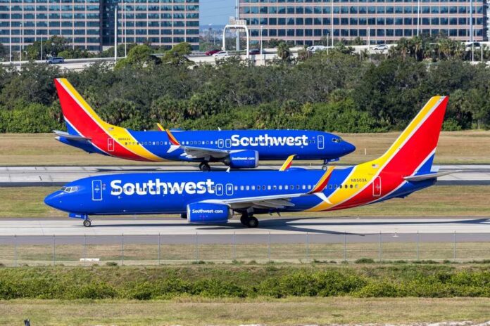 Two Southwest Airlines planes on an airport runway