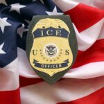 ICE officer badge placed on an American flag