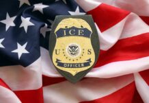 ICE officer badge placed on an American flag