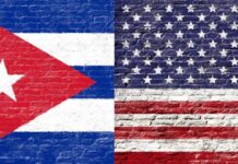 Cuban and American flags painted on a brick wall