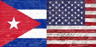 Cuban and American flags painted on a brick wall