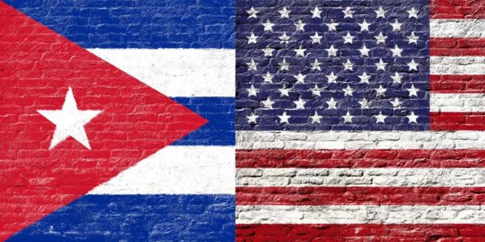 Cuban and American flags painted on a brick wall