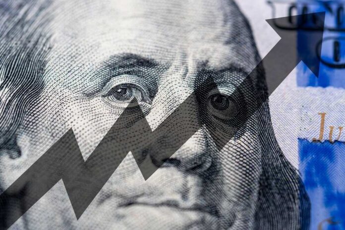 Close-up of a hundred-dollar bill with an upward trend graphic overlay