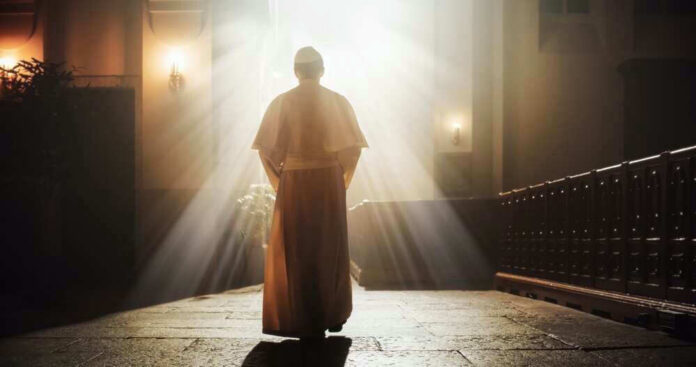 Person in religious attire bathed in sunlight.