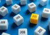 ADP’s Surprising Job Numbers A yellow cube with the word 'JOB' surrounded by white cubes with the same word on a blue background