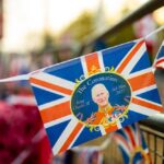A decorative banner celebrating the coronation of King Charles III with British flags