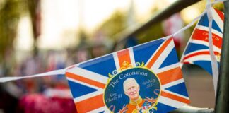 A decorative banner celebrating the coronation of King Charles III with British flags