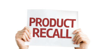 Hands holding a sign that reads 'PRODUCT RECALL'