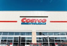 Exterior view of a Costco Wholesale store with shopping carts in front