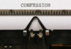 Close-up of a typewriter with the word 'CONFESSION' typed on paper