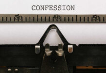 Close-up of a typewriter with the word 'CONFESSION' typed on paper