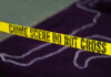 Chilling Discovery: Boxcar Tragedy Yellow crime scene tape marking off an area with a chalk outline