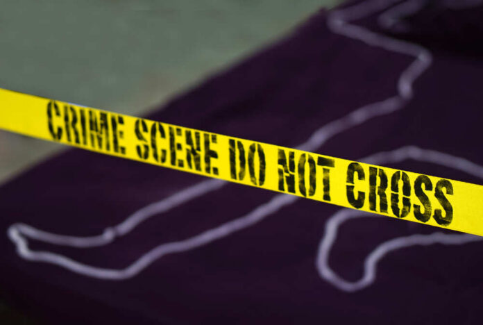 Yellow crime scene tape marking off an area with a chalk outline