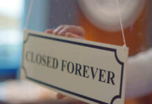 Century-Old Plant Vanishes – Closed Forever Closed forever sign being placed on window.