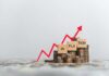 Graph showing inflation trend with coins and wooden blocks