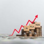 Graph showing inflation trend with coins and wooden blocks