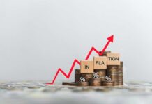 Graph showing inflation trend with coins and wooden blocks