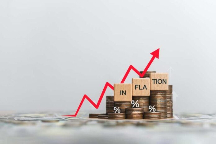 Graph showing inflation trend with coins and wooden blocks