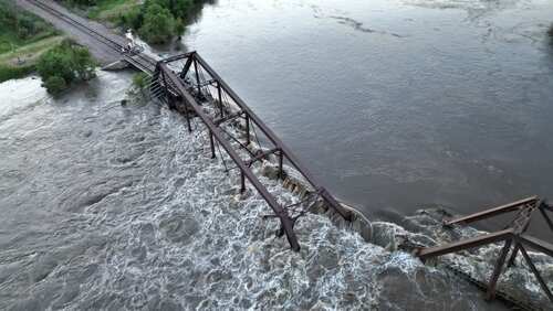 An,Aerial,View,Of,A,Partially,Collapsed,Railway,Bridge,Over