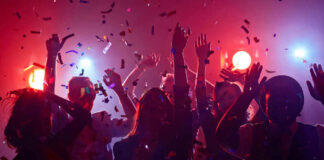 People dancing with confetti at a party.
