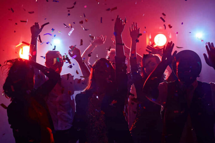 People dancing with confetti at a party.