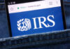 Magnifying glass focusing on IRS website logo.