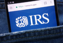 Magnifying glass focusing on IRS website logo.