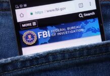 FBI Alarm: Computer Logins Exploited Mobile phone displaying the FBI website in a denim pocket